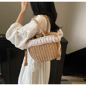 Detailed shot of handmade straw bag with delicate lace trim and colorful bead accents