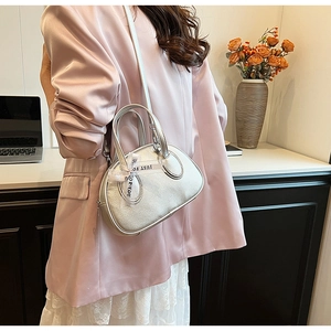 Detail of silver metallic handbag with荔枝 texture and Just For You ribbon detail