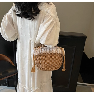 Detailed straw handbag featuring white lace trim and colorful beads for summer vacation