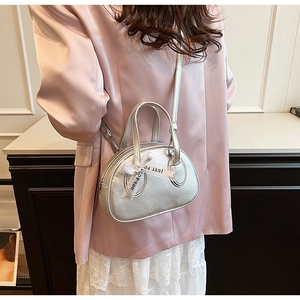 Detail of silver textured bowling bag featuring white organza ribbon and dual handles