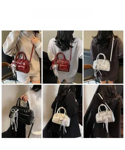 Detailed views of vintage style Boston bag with bow pendant in various colors