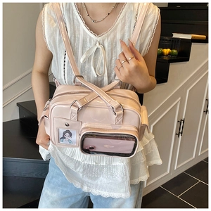 Pink high-gloss backpack detail featuring a transparent phone pocket and card slot