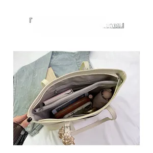 Interior view showing the large capacity and organized compartments of the beige tote bag