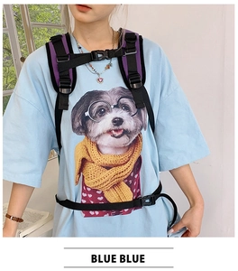 Detail of a casual blue t-shirt with cute puppy graphic and black backpack with purple straps