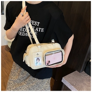 Detail view of beige ita bag with transparent PVC windows and silver hardware accents