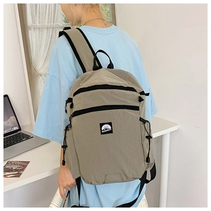 Side view of khaki checkered backpack showing large capacity and adjustable side straps