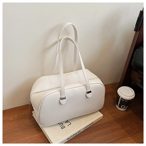 Detailed macro view of white pebble leather texture and metal zipper on minimalist handbag