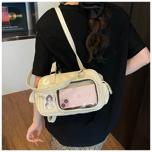 Detail of cream white PU leather ita bag showing transparent window and inner items