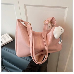 Detail of pink PU tote bag with gold metal buckle and cute cloud plush charm