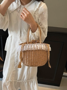 Pastoral straw handbag with white lace trim and drawstring closure for summer beach vacation