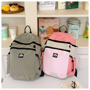 Close-up of nylon backpacks featuring multi-pocket design and mountain logo branding