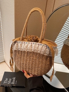 Handheld bohemian straw tote bag featuring white lace ruffles and colorful bead accents