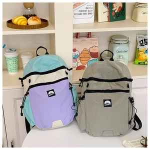 Detail view of large-capacity backpacks with multi-color patchwork and textured fabric