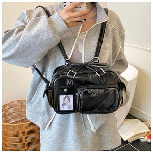 Detailed view of black glossy multi-pocket bowling bag with silver zipper accents