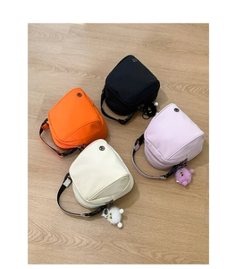 Mini shell bags in four colors with nylon texture and cute plush monster pendants