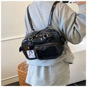 Detailed view of black high-gloss ita bag with multiple pockets and a clear display slot