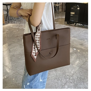 Brown lychee leather tote bag featuring front pocket and elegant houndstooth silk scarf