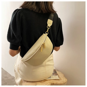 Detail of off-white lychee texture leather chest bag with golden metal zipper and wide strap