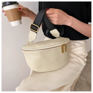 Detail of off-white crescent chest bag with lychee texture and wide nylon strap