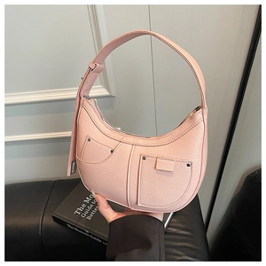 Pink lychee grain leather crescent bag with rivet pocket detail and chunky top handle