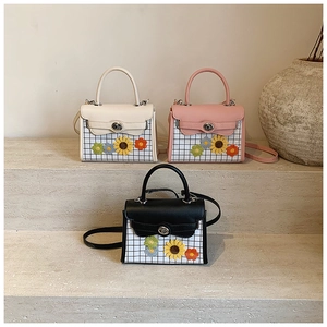 Three mini handbags in cream, pink and black with floral appliques and checkered fabric