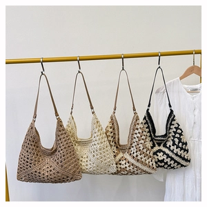 Detail of four handmade crochet beach bags with intricate patterns and leather straps