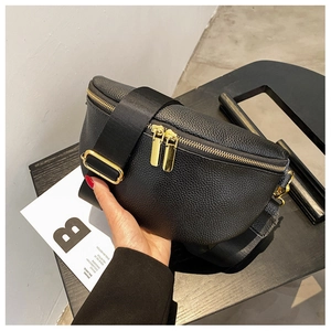 Detail of black lychee grain leather waist bag featuring premium gold double zippers