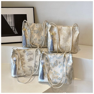 Detailed view of four vintage Chinese style bucket bags with floral butterfly embroidery