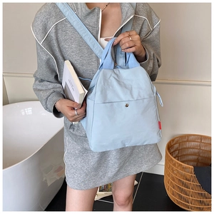 Light blue nylon multipurpose crossbody backpack with side red label for casual commute