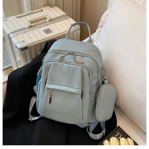 Detail of light blue lychee-textured backpack with detachable round coin purse