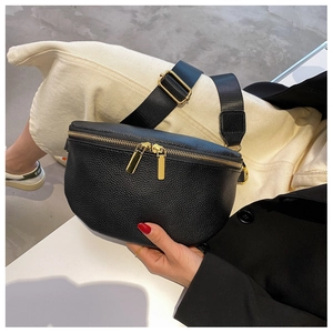 Close-up of black lychee texture leather waist bag with gold zippers and nylon strap