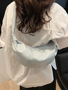 Light blue faux leather croissant crossbody bag with wide shoulder strap for women