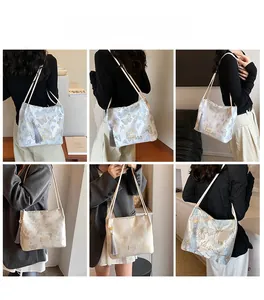 Detailed close-up of embroidered butterfly patterns and silk texture on the hanfu bucket bag