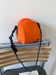 Fashionable bright orange shell crossbody bag with adjustable sporty strap for women