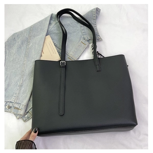 Close-up of black lychee-textured tote bag with a silk scarf and silver buckle detail