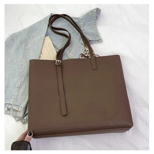 Detailed view of brown lychee grain tote bag featuring a decorative printed silk scarf