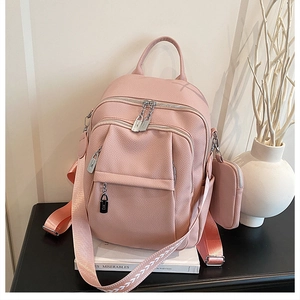 Detail of pink lychee texture backpack with metal zippers and mini matching pouch