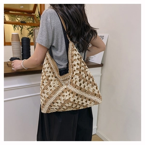 Detail view of handmade crochet tote bag with geometric cutout patterns for beach vacations