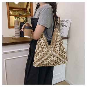 Detail of hand-woven checkerboard tote bag with beige and brown crochet pattern