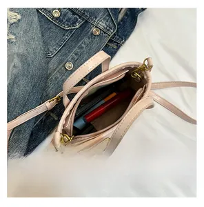 Internal view showing the spacious capacity of this nude PU leather bucket crossbody bag