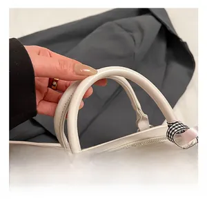 Close-up of comfortable white leather handle with lace and checkered bow detailing