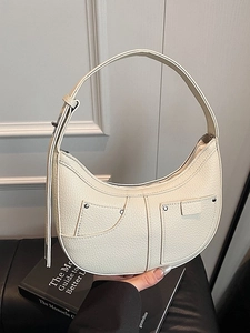 Minimalist cream white crescent shoulder bag with pebble grain leather and silver rivets