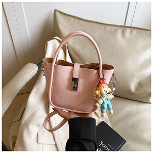 Pink bucket bag detail with silver twist lock and cute blue overall doll charm