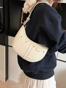 Fashionable cream white half-moon underarm bag with silver rivets and lychee grain texture