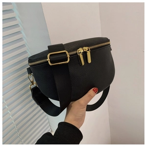 Detail of black lychee texture leather chest bag with gold double-zipper and wide strap