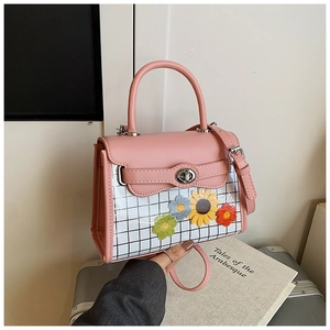 Sac à main rose avec empiècements en résille florale et bandoulière réglable