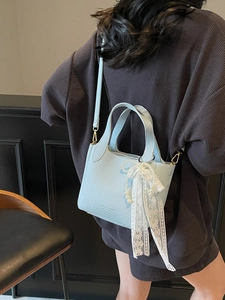 Sky blue litchi leather bucket bag with pearl bow charm and adjustable shoulder strap