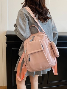Pink lychee texture leather backpack with matching round coin purse and woven straps