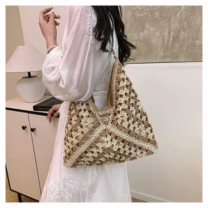 Detailed view of bohemian style woven tote bag with geometric beige and brown pattern