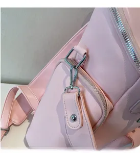 Detail of premium silver hardware and smooth pink leather texture on this fashion backpack